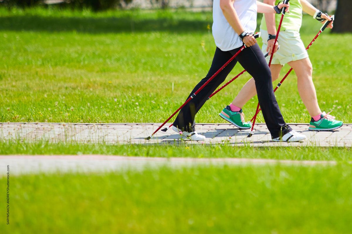 Fernansicht auf eine Frau und einen Mann beim Nordic Walking. Die Art der Bewegung ist nicht so entscheidend, Hauptsache Bewegung.